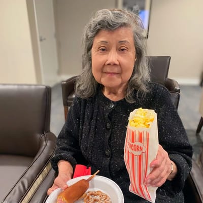 Resident enjoying snacks in a cozy lounge area