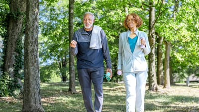 Two residents exercising together outdoors