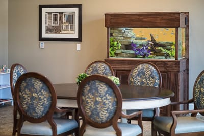 Dining area with an aquarium and artwork