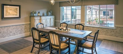 Bright dining room with a large table and windows