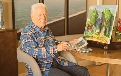 Resident painting in an activity room