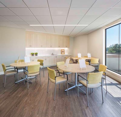 Bright interior of a multi-purpose room with tables and chairs