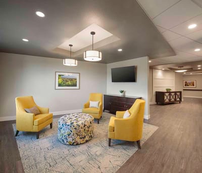 Cozy common area with yellow chairs and a decorative table