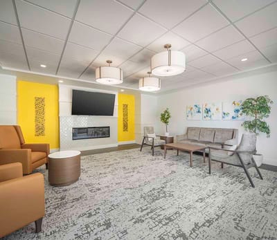 Bright common area with comfortable seating and a fireplace
