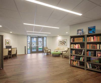 Bright common area with bookshelves and seating
