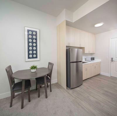 Cozy resident room with a dining table and kitchenette