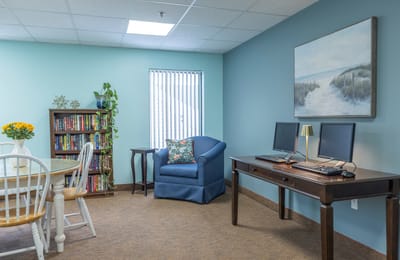 Cozy activity room with computers and seating
