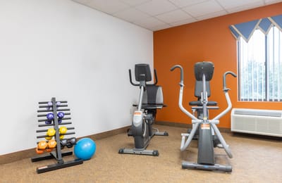 Fitness area with exercise equipment including weights and bikes