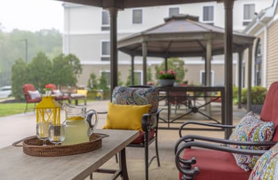 Outdoor seating area with lemonade and flowers