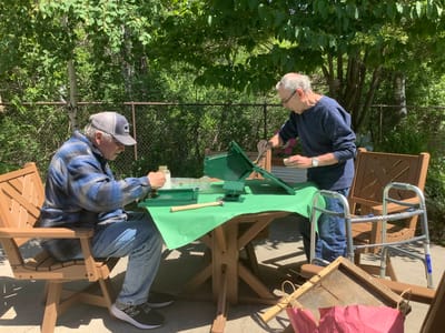 Two residents engaged in an outdoor painting activity