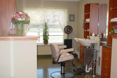 A salon area with styling chair and sink