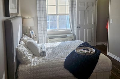 Cozy resident room with a bed and natural light