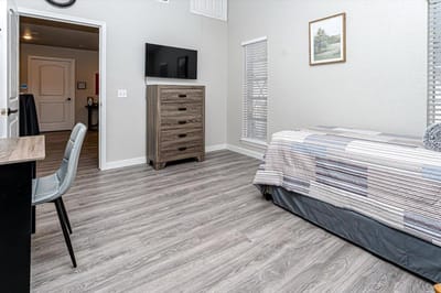 Cozy private room with bed and dresser