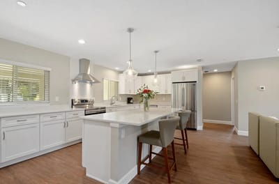 Modern kitchen interior with bar stools and flowers