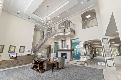 Bright lobby with elegant staircase and seating area