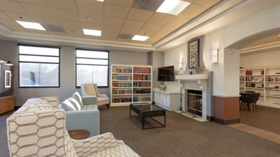 Bright interior common area with bookshelves and seating