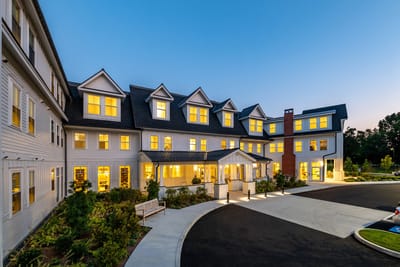 Front exterior of The Residence at Bedford during twilight