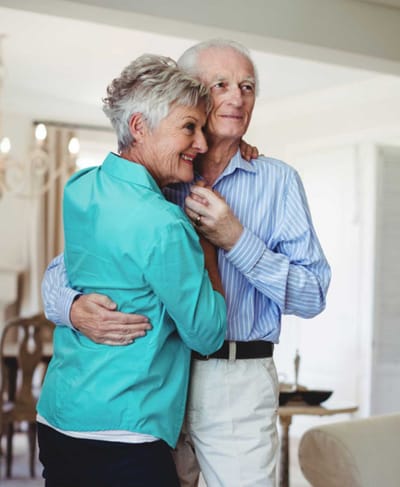 Senior couple dancing joyfully in a bright interior