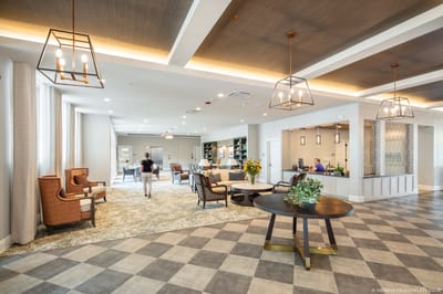 Bright common area with residents and staff