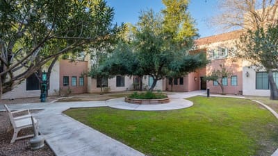 Outdoor courtyard with greenery and seating areas