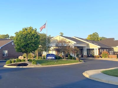 Exterior view of the nursing home facility with a flag