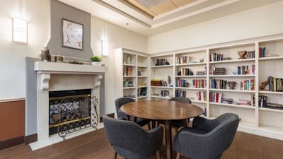 Cozy common area with a round table and bookshelves