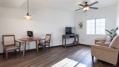 A well-lit interior room with dining table and seating