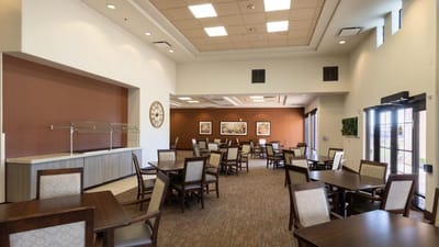 Dining room with tables and chairs in a bright space