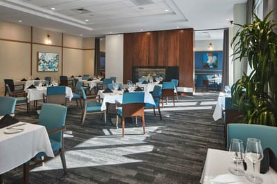 Elegant dining room with tables set for meals