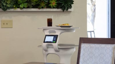 A meal tray with food and drink in a dining area