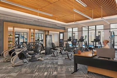 Fitness area with exercise equipment and a staff member