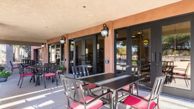 Outdoor seating area with tables and chairs