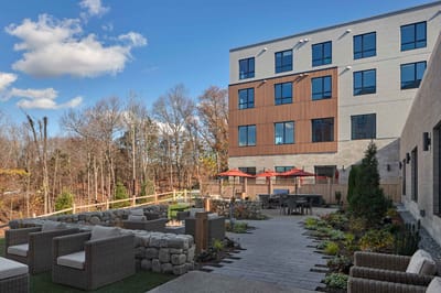 Outdoor patio space with seating and landscaping
