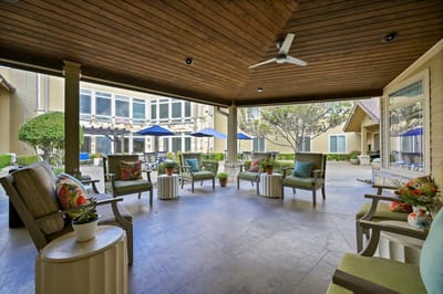 Outdoor seating area with green chairs and tables