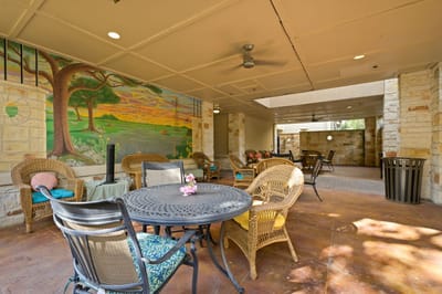 Outdoor seating area with mural and chairs