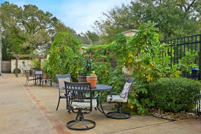 Outdoor patio area with seating and greenery