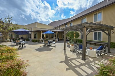 Outdoor seating area with umbrellas and landscaping