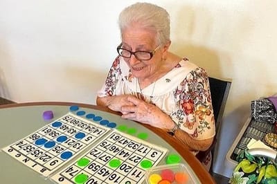 Resident playing bingo in an activity room