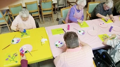 Residents engaged in a painting activity