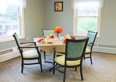 A dining table set for breakfast in a bright room