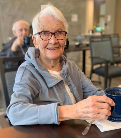 Resident enjoying a drink in the common area
