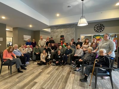 Residents and staff posing together in a common area