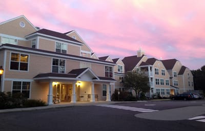 Exterior of a senior living facility at sunset