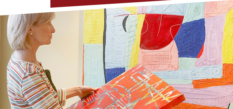 Resident engaging in art activity with a colorful painting
