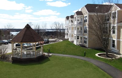 Exterior view of a senior living facility with a gazebo