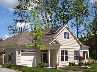 Exterior view of a senior living facility with trees