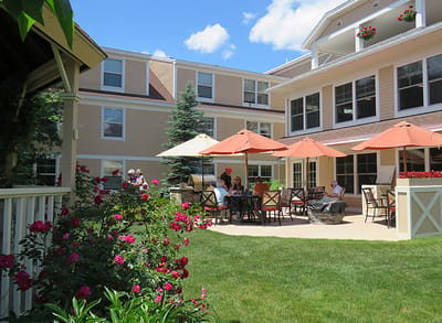 Residents enjoying outdoor seating in a garden area
