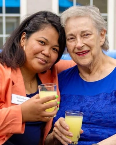 Staff and resident enjoying drinks at an event