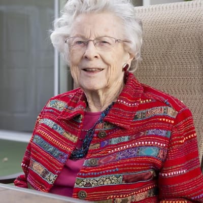 Smiling resident in a colorful sweater