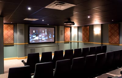 A cozy movie theater room with rows of seats